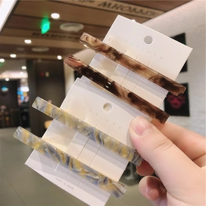 Chic set of two marble texture hair clips with minimalist acetate design for women