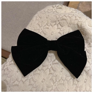 Elegant large black velvet bow hair clip on lace background for women's autumn winter style