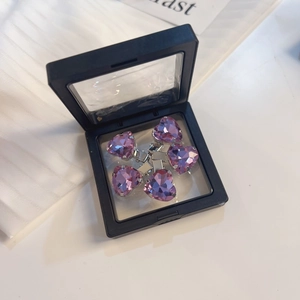 Detail van 5 roze hartvormige haarspelden met strassteentjes in zwarte zwevende display