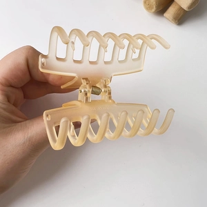 Detail of matte jelly beige hair claw clip with strong metal spring mechanism