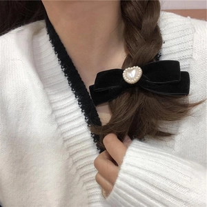 Elegant black velvet bow hair clip with heart pearl on braided hair for women
