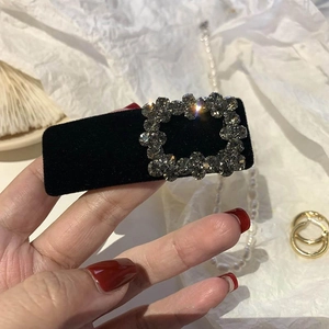 Baroque black velvet hair clip with a square dark rhinestone buckle accessory