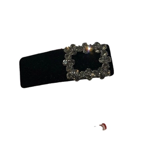 Baroque black velvet hair clip with a sparkling rhinestone buckle on white background