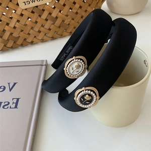 Detail of elegant black velvet headbands featuring vintage camellia flower pearl charms