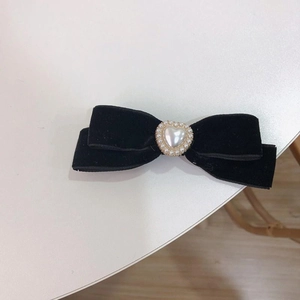 Elegant black velvet bow hair clip with heart pearl centerpiece and gold rim