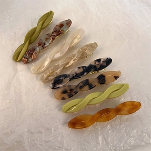 Macro detail of eight acetate twist hairpins in various marble and tortoiseshell patterns