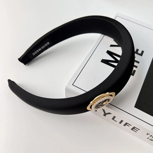 Detailed view of handmade black satin headband with elegant pearl tulip metal buckle