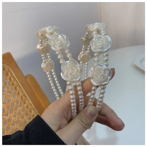 Detail of double-layer headband with elegant camellia flowers and ivory pearls