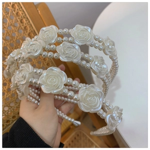 Detail of elegant white pearl headband featuring exquisite 3D resin rose flower accents