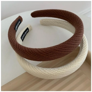 Detail of hand made knitted padded headbands in brown and beige with texture view
