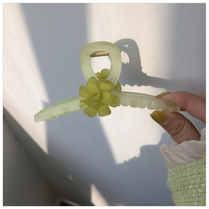 Détail de la pince à cheveux muguet vert forêt mat avec un design floral élégant