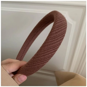 Detailed view of dark brown ribbed knit fabric padded headband with soft textured finish