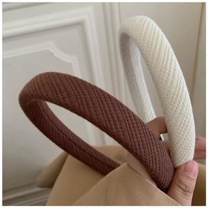 Close-up of thick knitted ribbed headbands in coffee and beige for hair volume