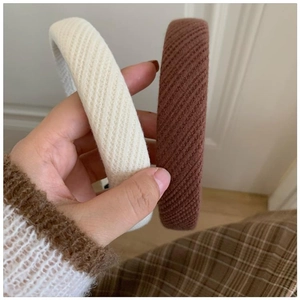 Close-up of thick sponge headbands in beige and brown with twill texture and non-slip lining