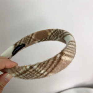 Plaid wool headband for women featuring a handmade label and warm winter texture