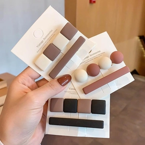 Vintage matte resin hair clips set in earth tones with hand-held display card
