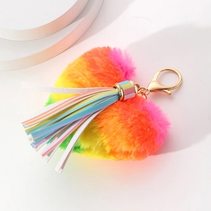Rainbow plush heart keychain with colorful leather tassel and gold metal ring on white stand