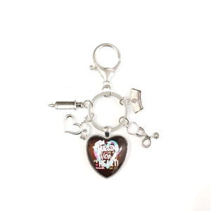 Nursing is a work of heart medical keychain with syringe nurse hat and stethoscope charms