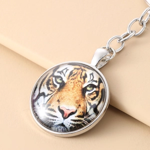 Tiger pattern glass cabochon keychain with silver metal frame and circular design