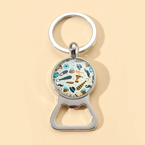 Detail of silver metal Father's Day keychain featuring beer bottle opener and tie motif