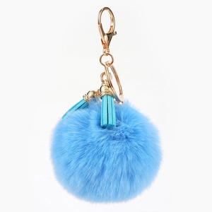 Porte-clés pompon en fourrure bleue avec fermoir doré et pompons en cuir assortis