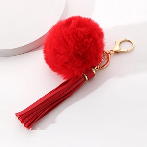 Furry red pompom keychain with long tassels and gold metal clip for bags and car keys