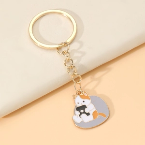 Détail d'un porte-clés chat de dessin animé avec finition en alliage doré et émail coloré
