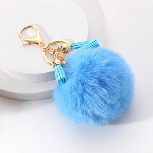 Porte-clés pompon en fausse fourrure bleu ciel avec fermoir doré et deux glands