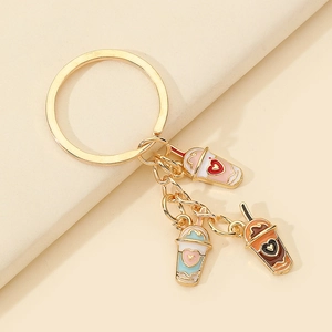 Detail of creative bubble tea keychain with pink blue and brown enamel drink pendants