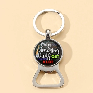Detail of metal bottle opener keychain with Father's Day engraving on light background