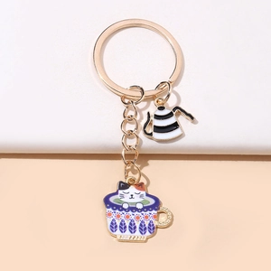 Detail of creative gold metal teacup cat keychain with enamel coffee pot charm