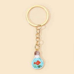 Detail of creative light bulb keychain with red fish and green seaweed inside