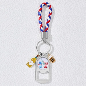 Detail of USA flag metal bottle opener keychain with woven red white and blue leather strap