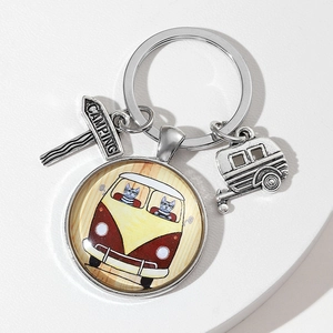 Silver car logo keychain with cats driving a vintage bus and camping charms