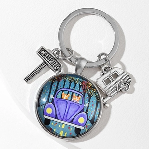 Outdoor camping themed keychain with glass pendant and silver trailer charm hanging