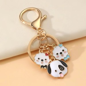 Detail of cute cartoon dog charms on a gold lobster clasp keychain for bags