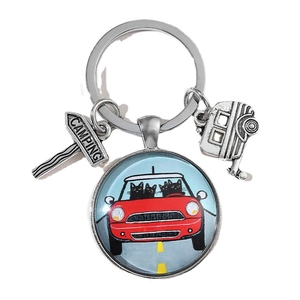 Camping keychain with cartoon black cats driving red car and silver camping pendants