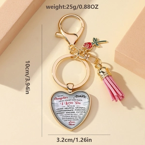 Detail view of heart-shaped keychain with red rose charm and pink suede tassel for mothers