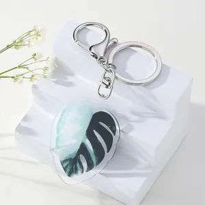 Detail of Monstera leaf acrylic keychain with silver metal lobster clasp and ring