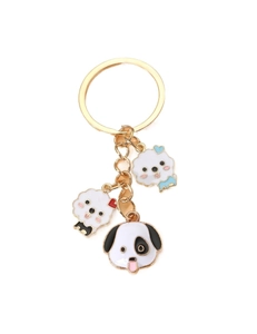 Detail of creative cartoon dog keychains with gold metal rings and enamel charms