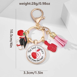 Detailed view of teacher appreciation keychain with apple, tassel and graduation charms