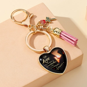 Golden heart keychain detail with grandmother granddaughter quote and pink leather tassel