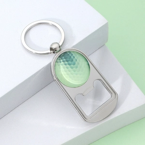 Golf ball themed metal keychain bottle opener on a minimalist white display block
