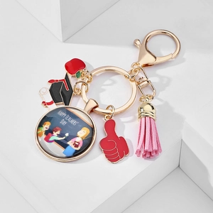 Detailed view of teacher appreciation keychain with apple, tassel and glass pendant