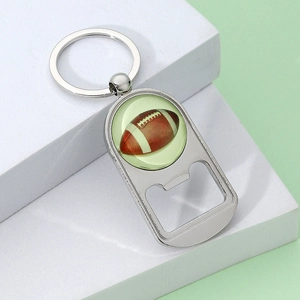 Silver metal American football keychain bottle opener on a light green background