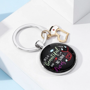 Detailed close-up of nurse keychain with artistic text and medical charms on a white stand