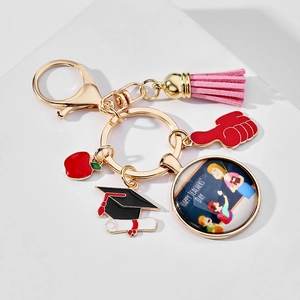 Detail of Teacher Appreciation keychain with pink tassel, apple charm and glass pendant