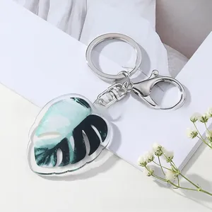 Detail of Monstera leaf acrylic keychain with green patterns and silver lobster clasp