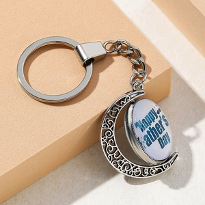 Detailed close-up of Father's Day keychain with crescent pendant and blue glass inlay decoration