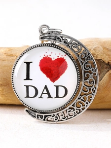 Macro shot of rotating Father's Day keychain with DAD heart glass cabochon in crescent frame